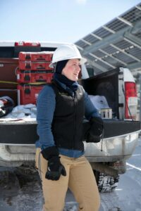 encore employee leaning against tailgate in winter
