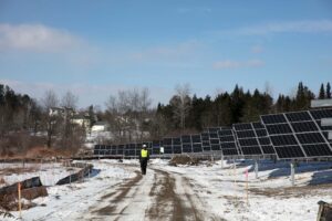 encore worker walking by new solar installation