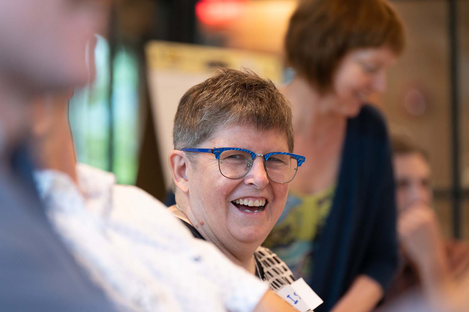 worker with blue glasses smiling